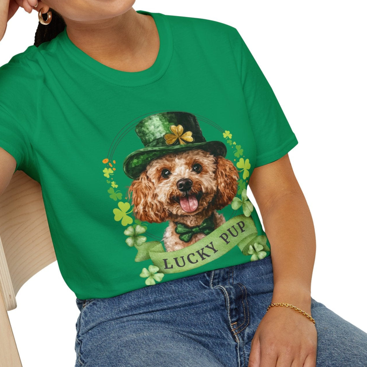 A woman in a St. Patrick’s Day kelly green t-shirt gift for dog lovers featuring a toy poodle dog with a shamrock garland and festive Irish design
