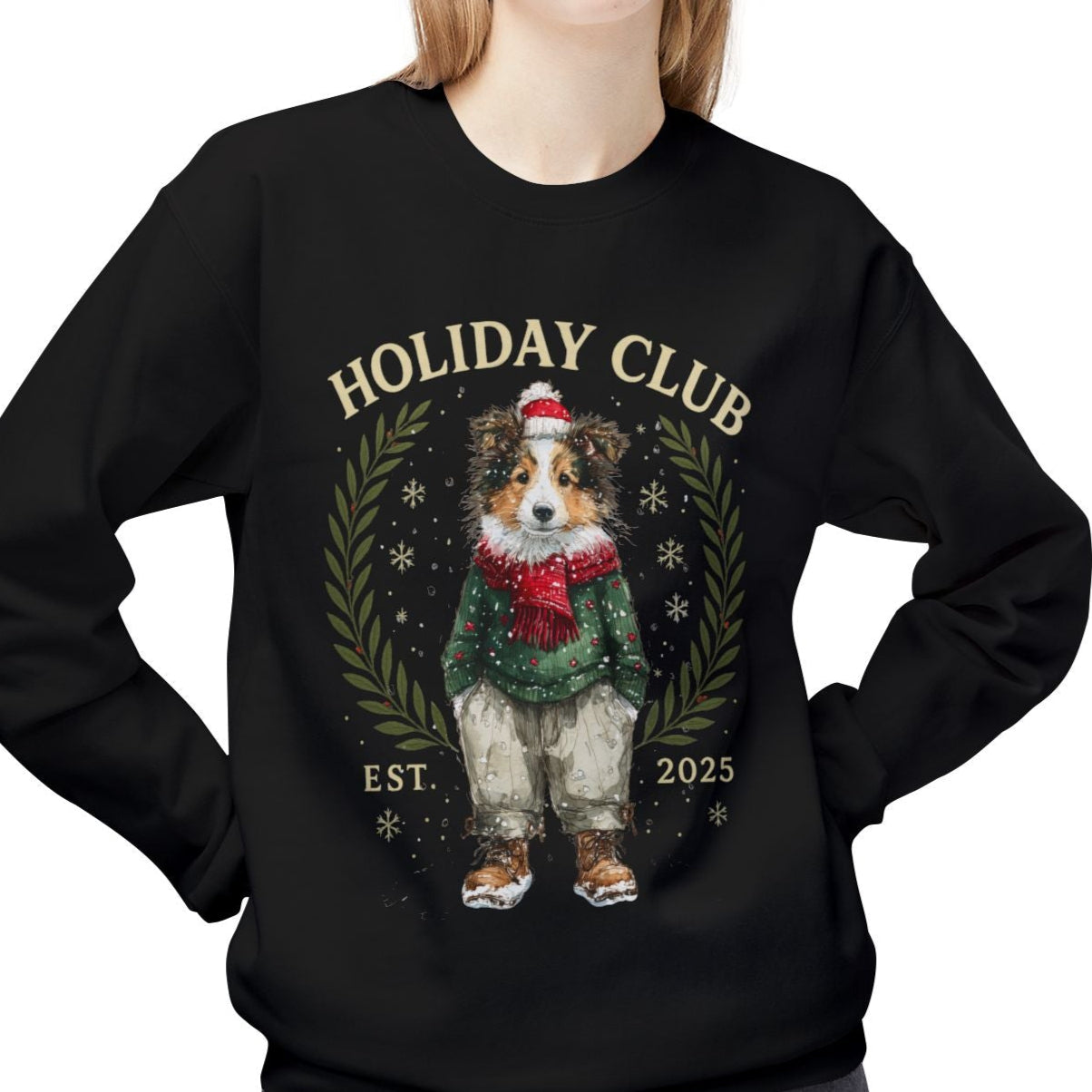 Person wearing a black sweatshirt with a holiday-themed design featuring a dog and text.