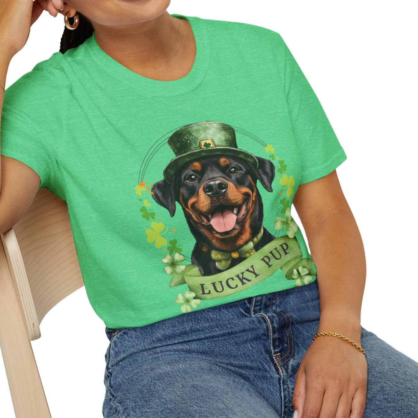 A woman in a St. Patrick’s Day heather kelly green t-shirt gift for dog lovers featuring a Rottweiler dog with a shamrock garland and festive Irish design