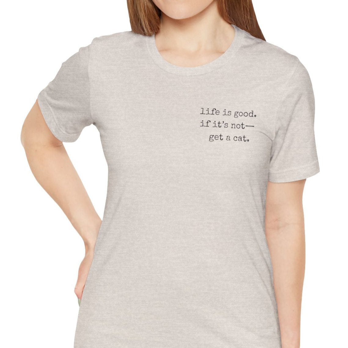 Woman wearing a light gray t-shirt with text on a white background