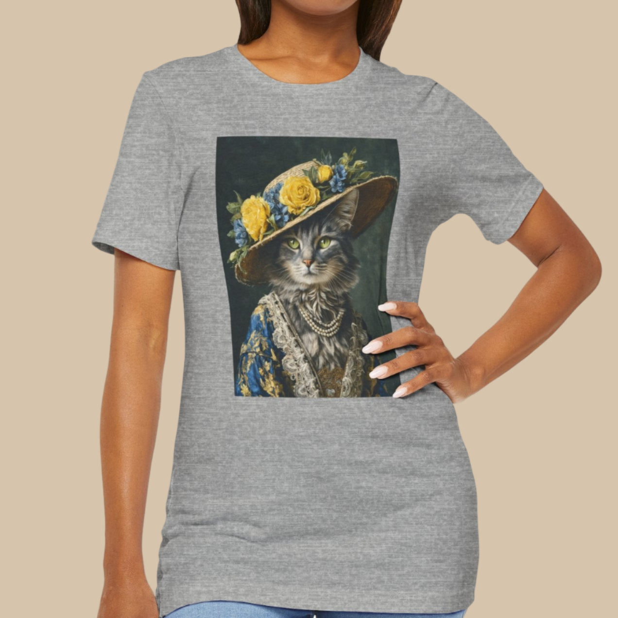 Woman wearing a gray t-shirt with a cat in a hat graphic design on a white background