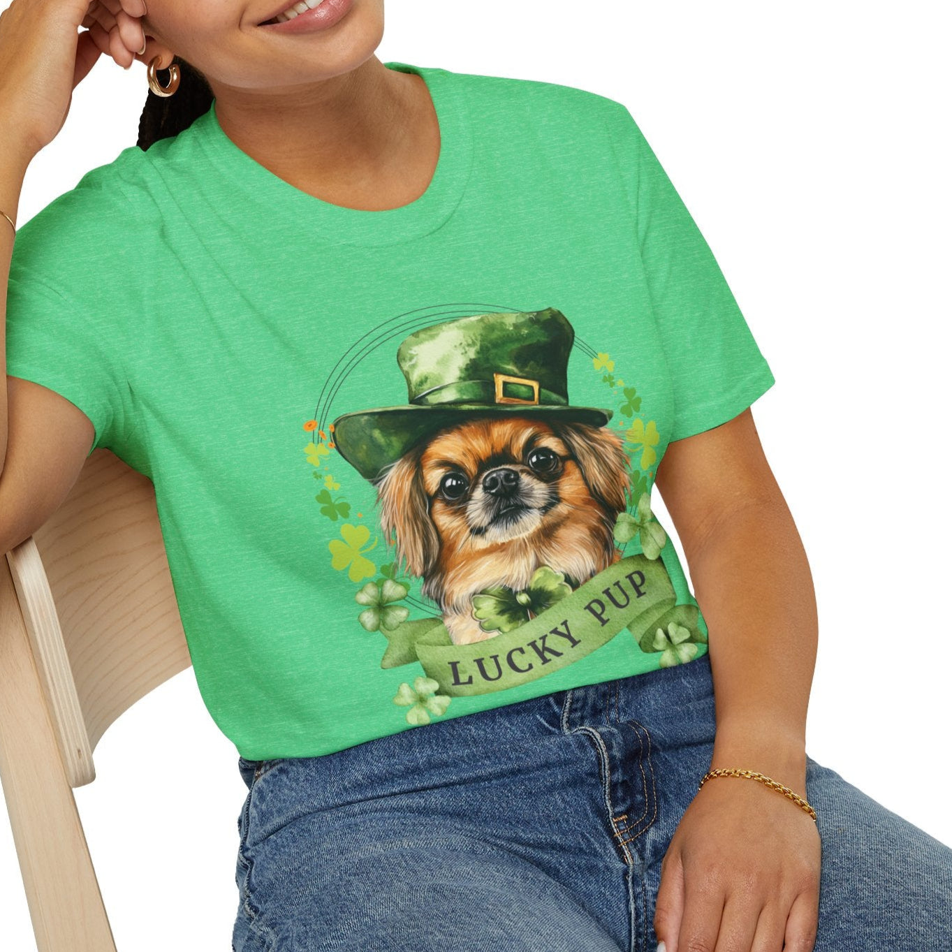 A woman in St. Patrick’s Day heather kelly green t-shirt gift for dog lovers featuring a Pekingese dog with a shamrock garland and festive Irish design