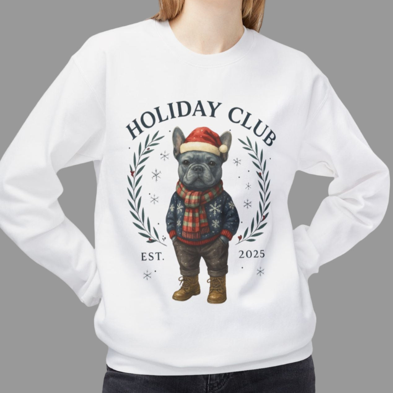 Person wearing a white sweatshirt with a holiday-themed design on a white background