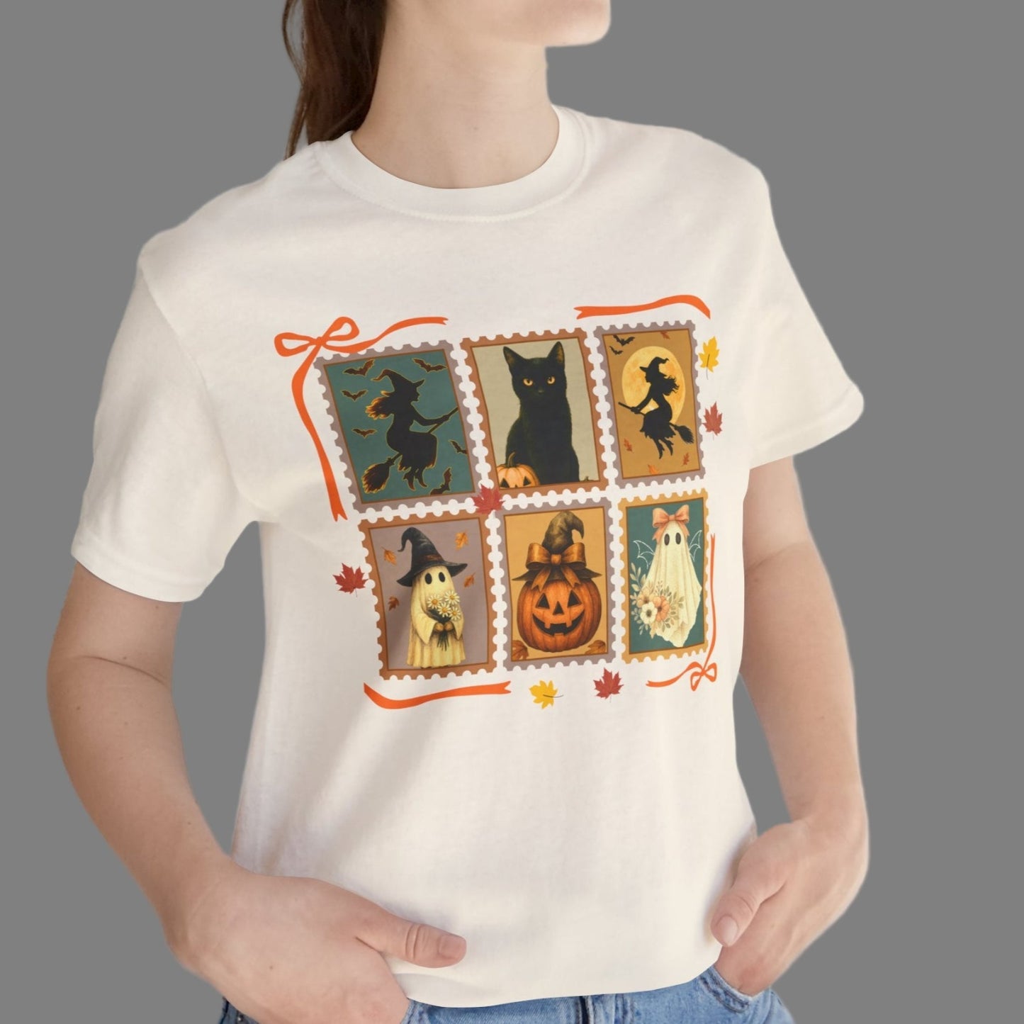Person wearing a white t-shirt with Halloween-themed design, standing against a plain background.