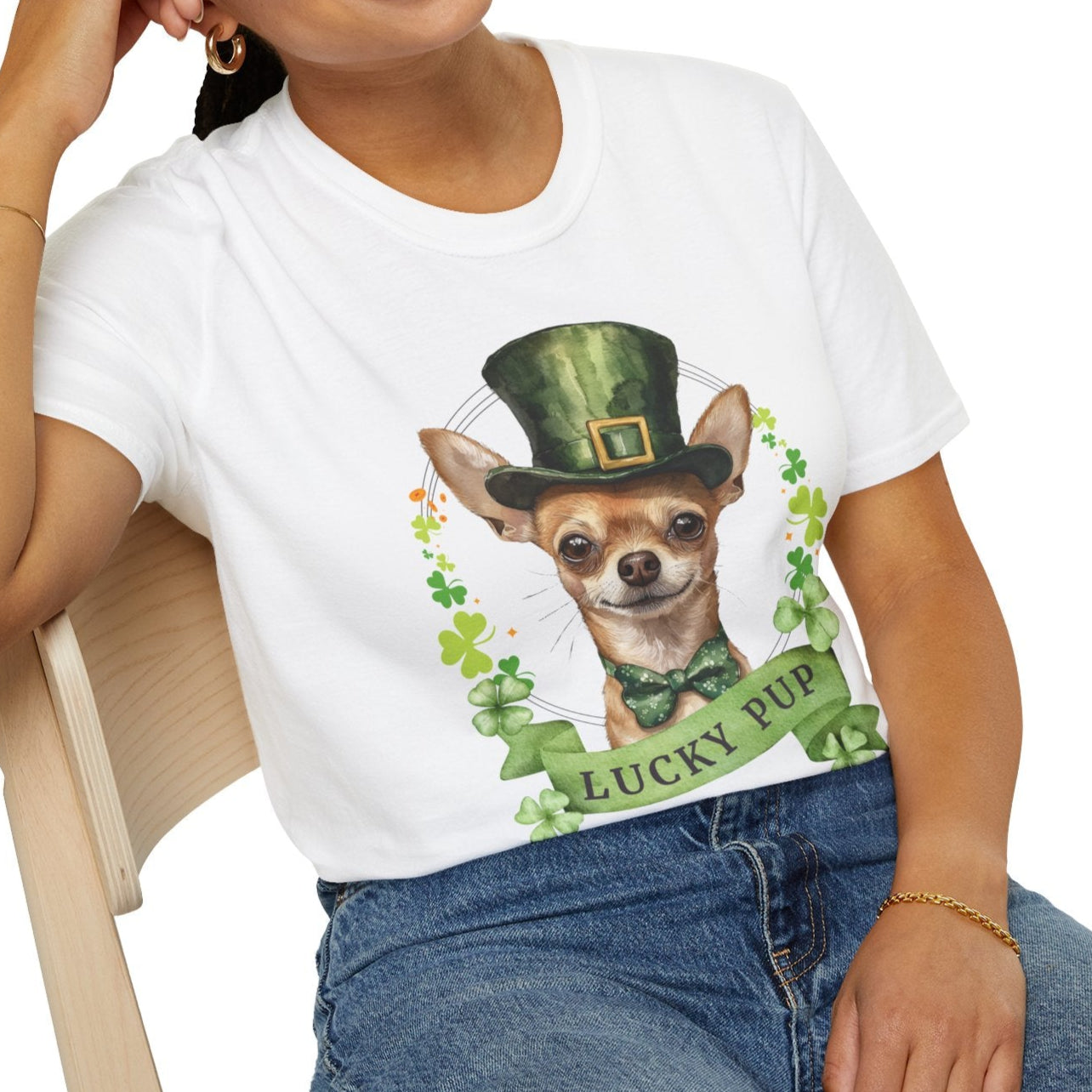 a woman in a white St. Patrick’s Day t-shirt featuring a Chihuahua dog with a shamrock garland and festive Irish design