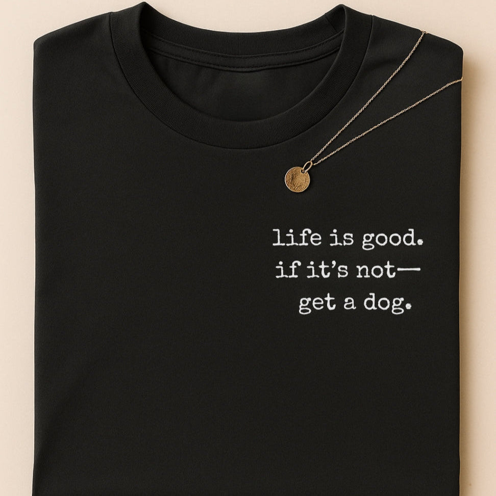 Black t-shirt with 'life is good. if it's not-get a dog.' text on a beige background