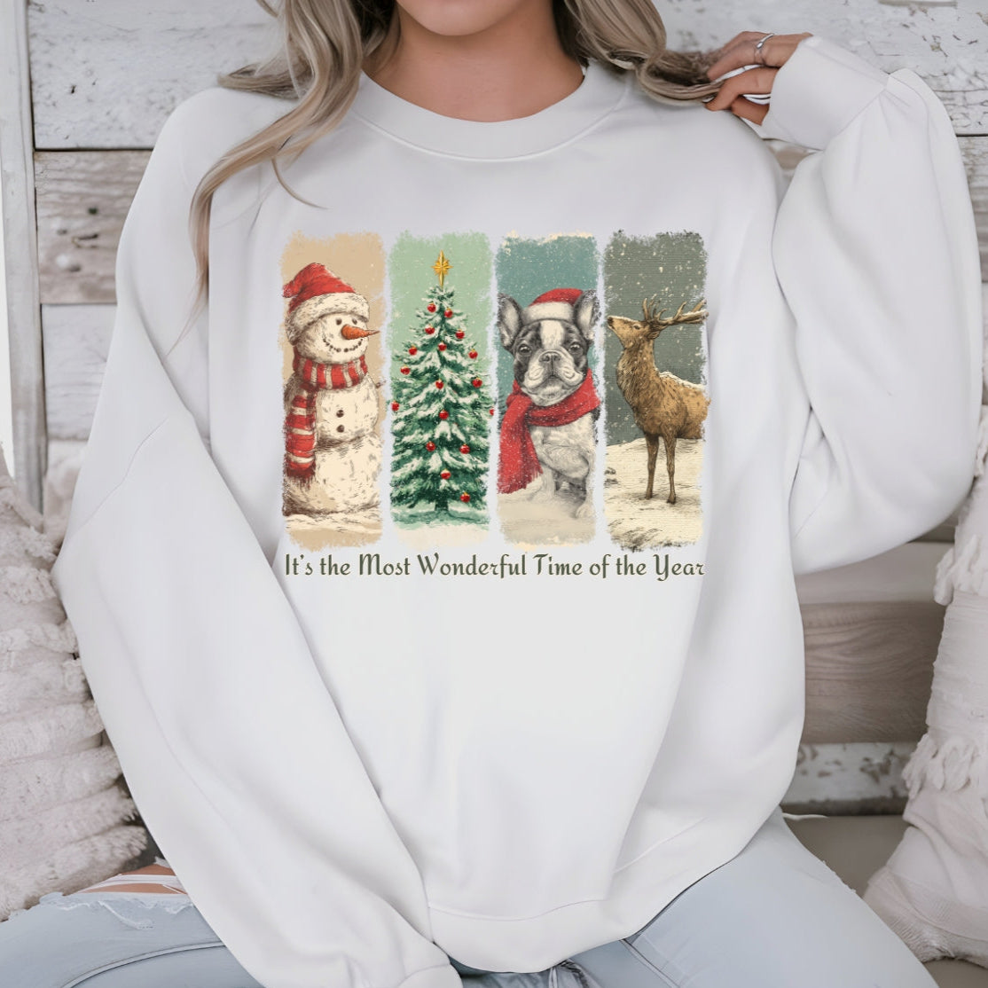Person wearing a white sweatshirt with Christmas-themed graphics and text.