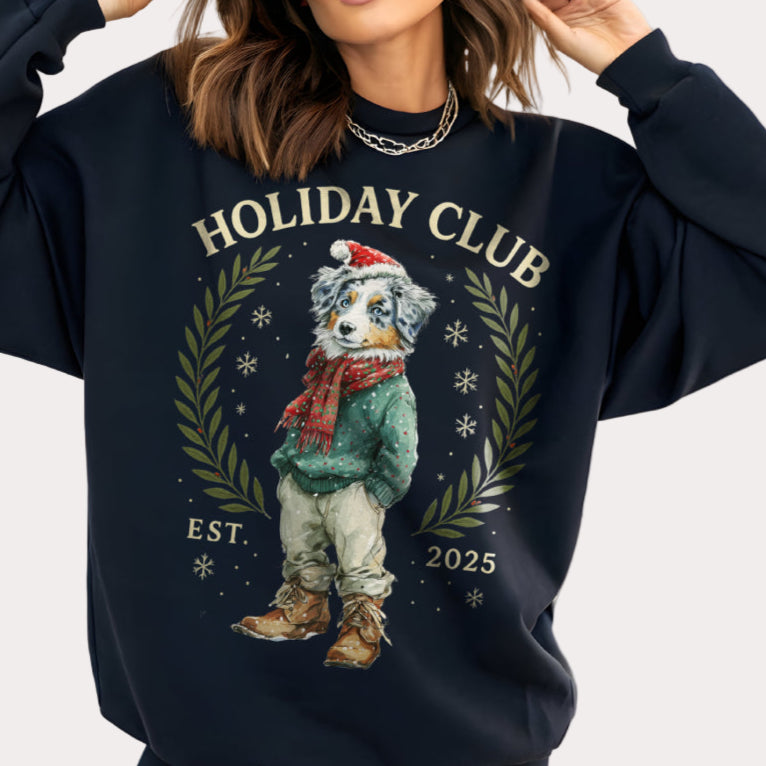 Person wearing a navy blue sweatshirt with 'Holiday Club' design featuring a dog in winter attire.