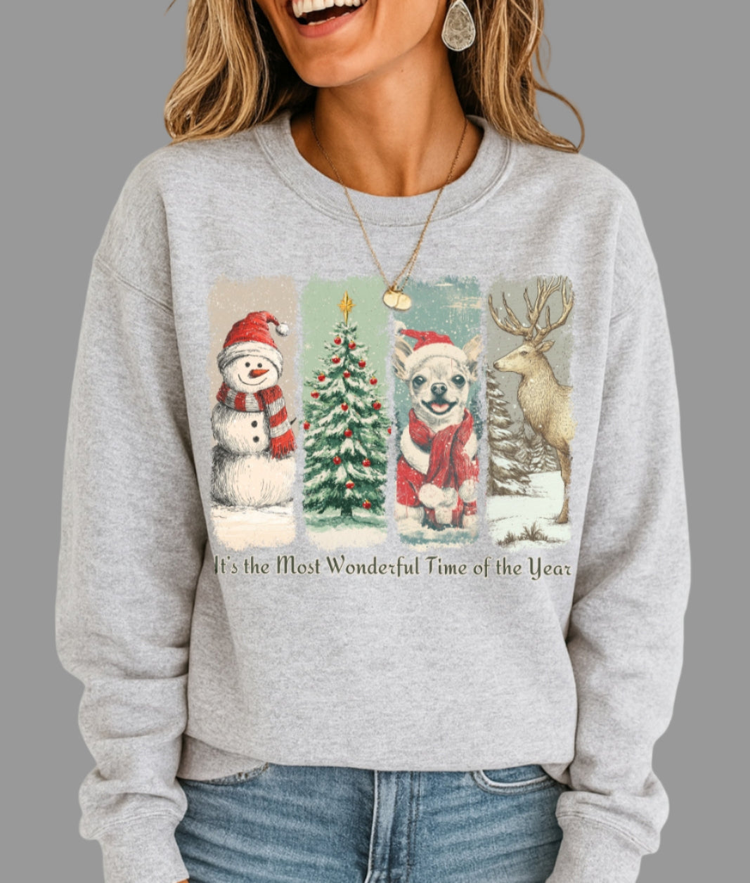 Woman wearing a gray sweatshirt with Christmas-themed graphics and text.