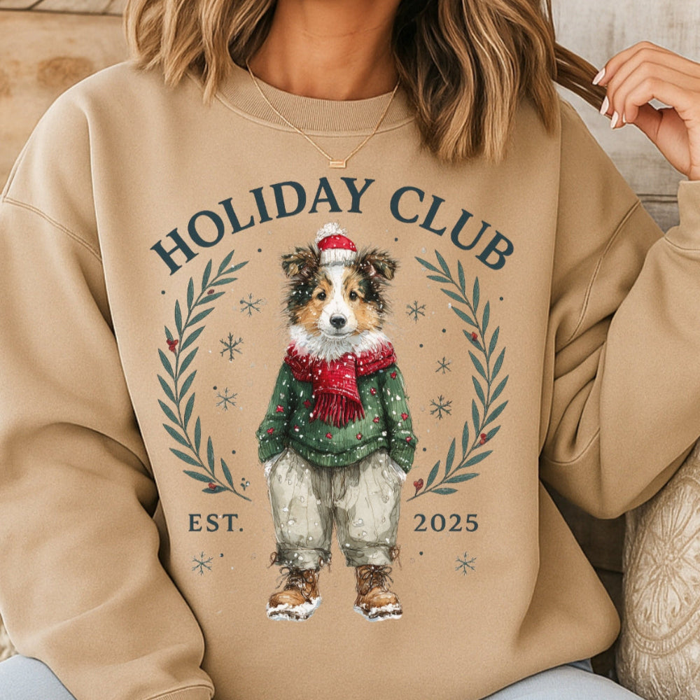 Beige sweatshirt with a dog illustration and 'Holiday Club' text worn by a person.