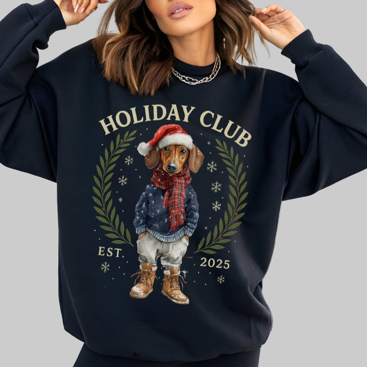 Person wearing a navy blue sweatshirt with 'Holiday Club' and a dog graphic in a room.