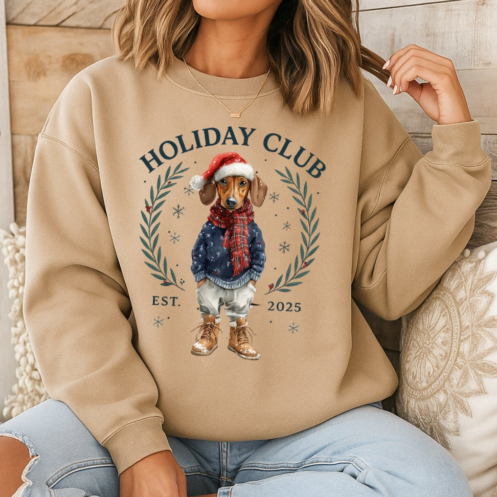 Person wearing a beige sweatshirt with a Christmas-themed design and text.