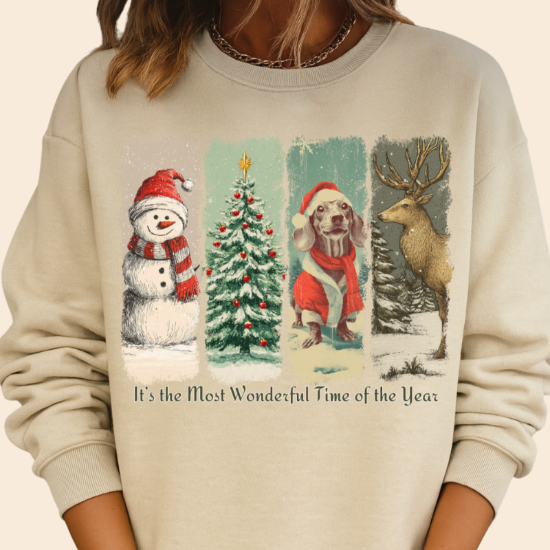 Beige sweatshirt with Christmas-themed design featuring a snowman, tree, dog, and deer.