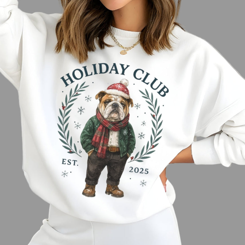 Woman wearing a white sweatshirt with a holiday-themed design featuring a dog and text.