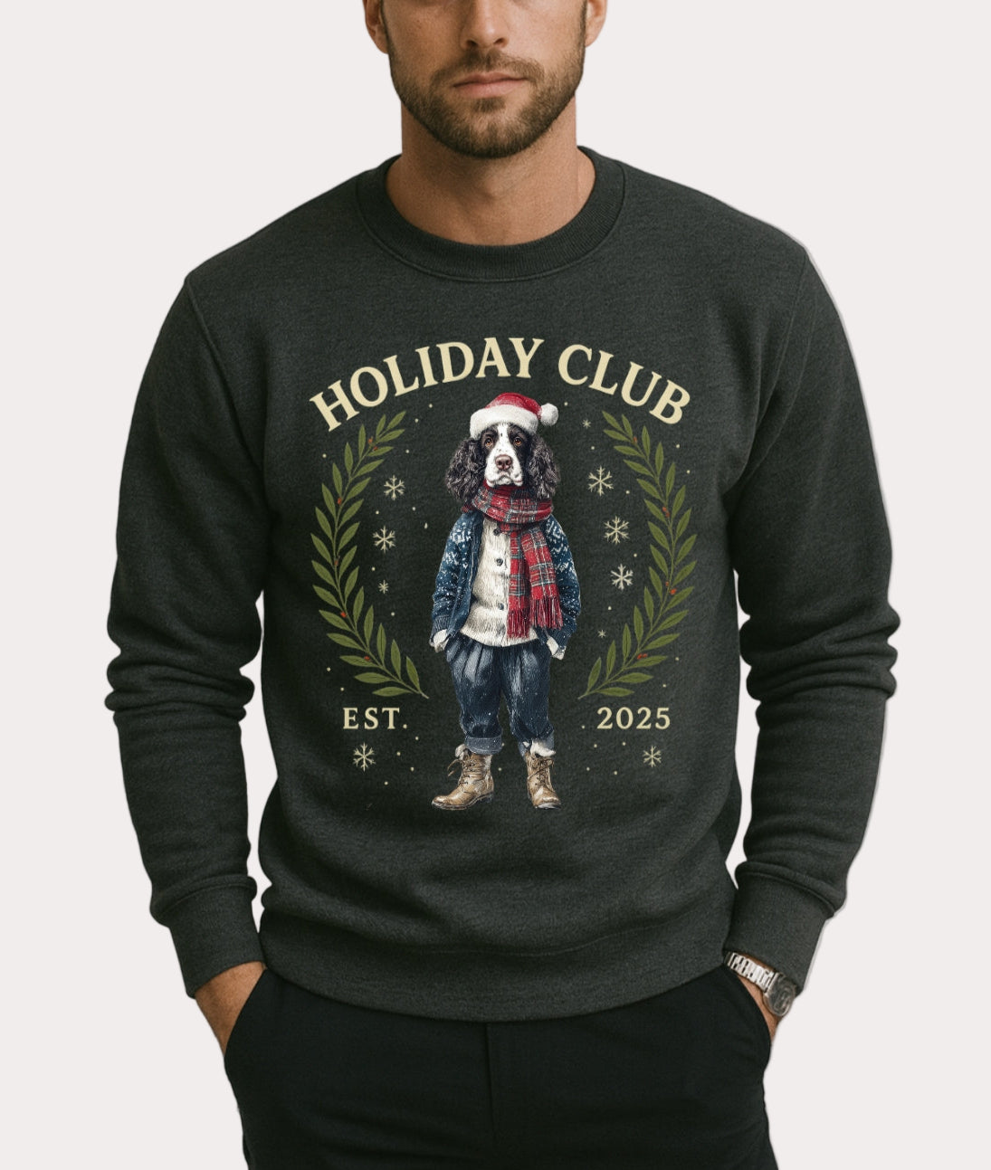 Man wearing a dark gray sweatshirt with 'Holiday Club' design featuring a dog and text on a plain background