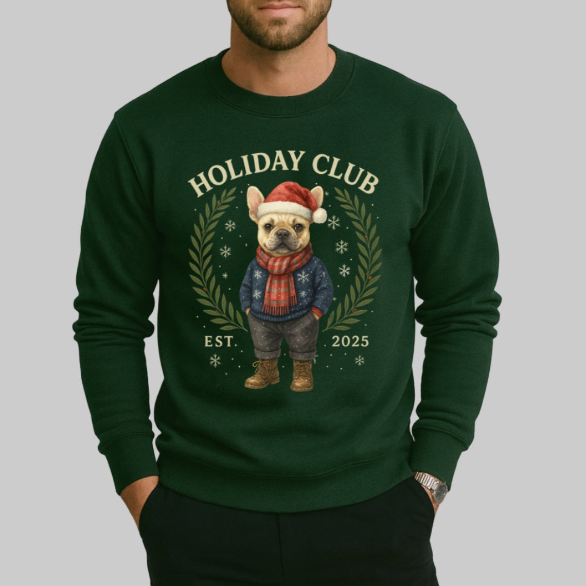 Man wearing a green sweatshirt with a festive design and text on a plain background