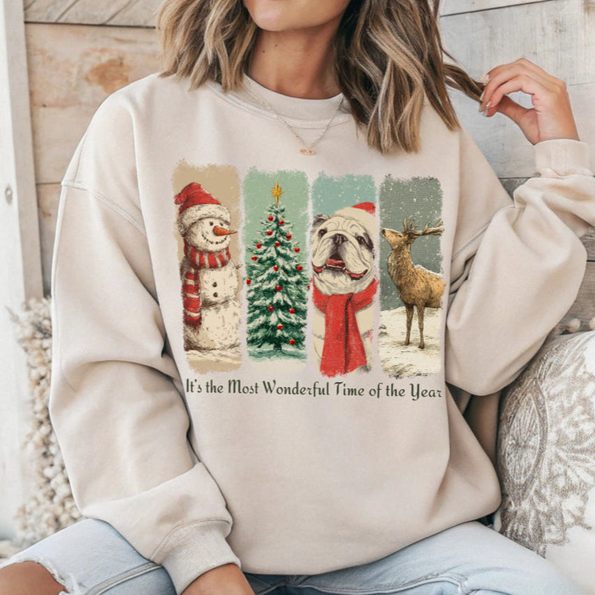 Person wearing a beige sweatshirt with Christmas-themed graphics and text.