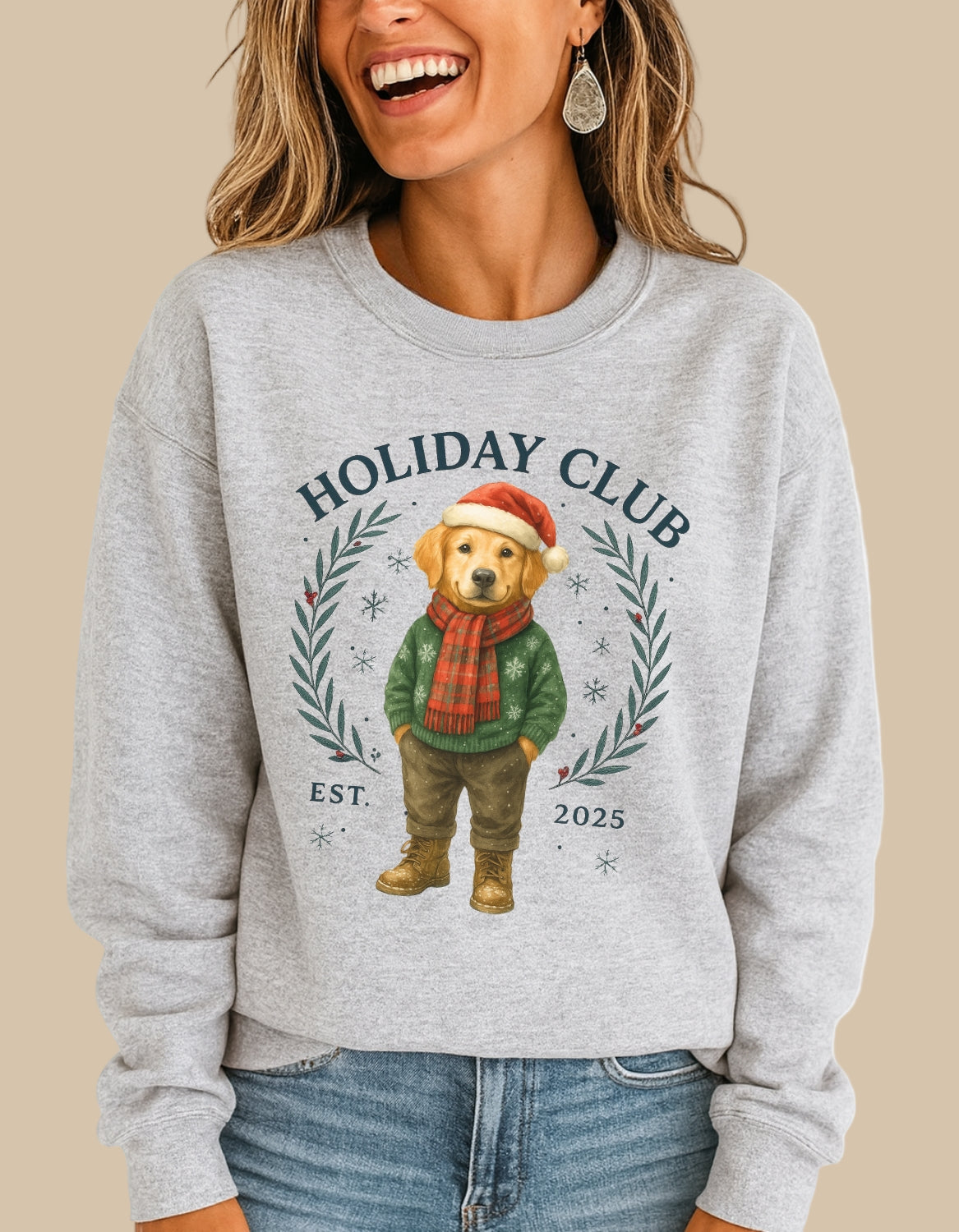 Person wearing a gray sweatshirt with a holiday-themed design featuring a bear, text 'Holiday Club', and year '2025'.