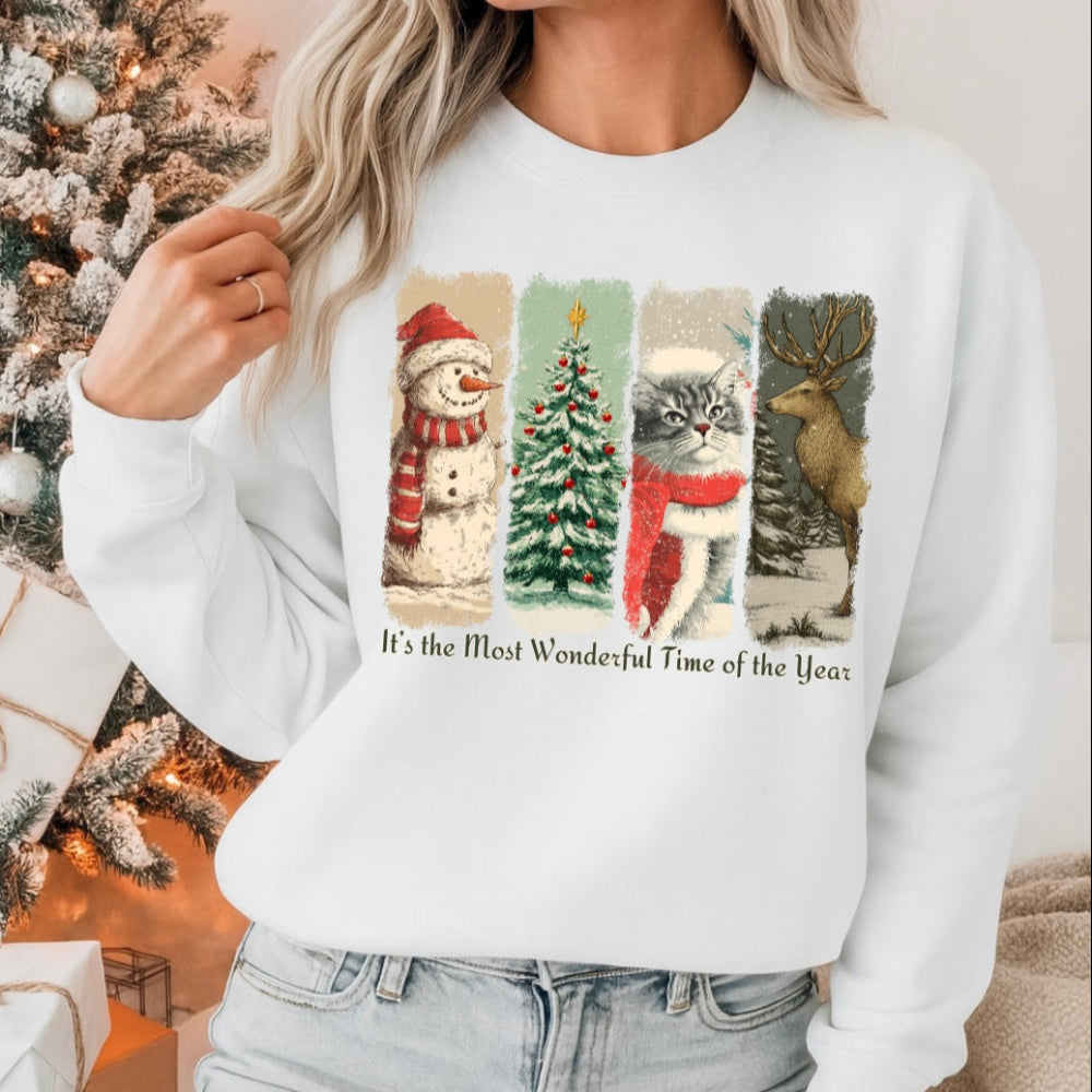 Person wearing a white sweatshirt with Christmas-themed design in front of a decorated Christmas tree.