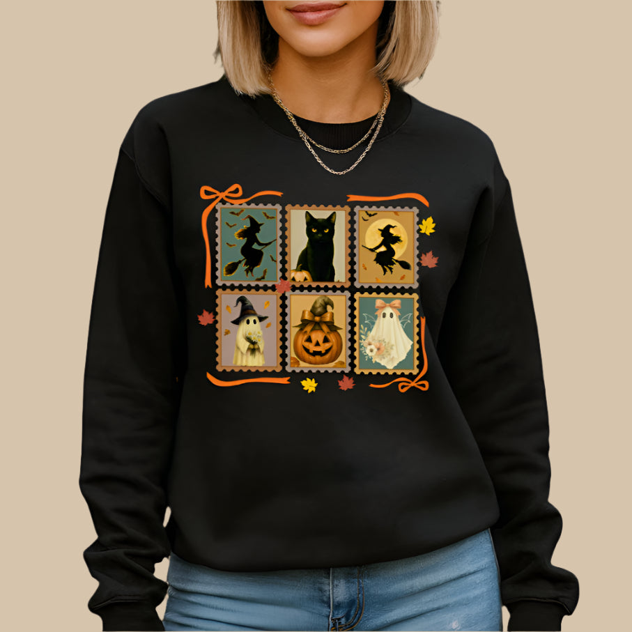 Person wearing a black Halloween-themed sweatshirt with graphics in an outdoor setting with pumpkins and fall decorations.