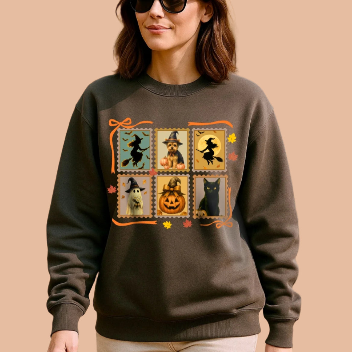 Woman wearing a charcoal sweatshirt with Halloween-themed design