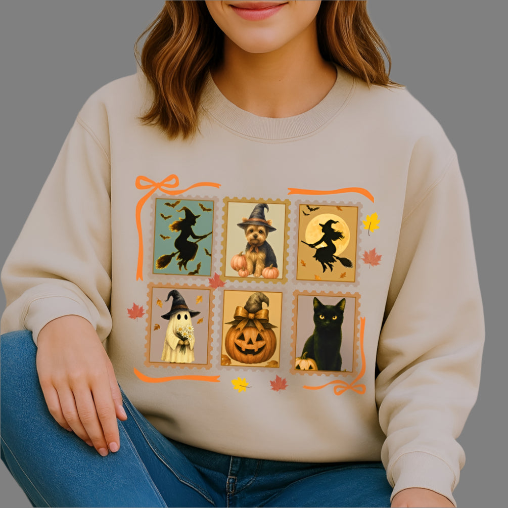 Woman wearing a beige sweatshirt with Halloween-themed graphics sitting against a plain background