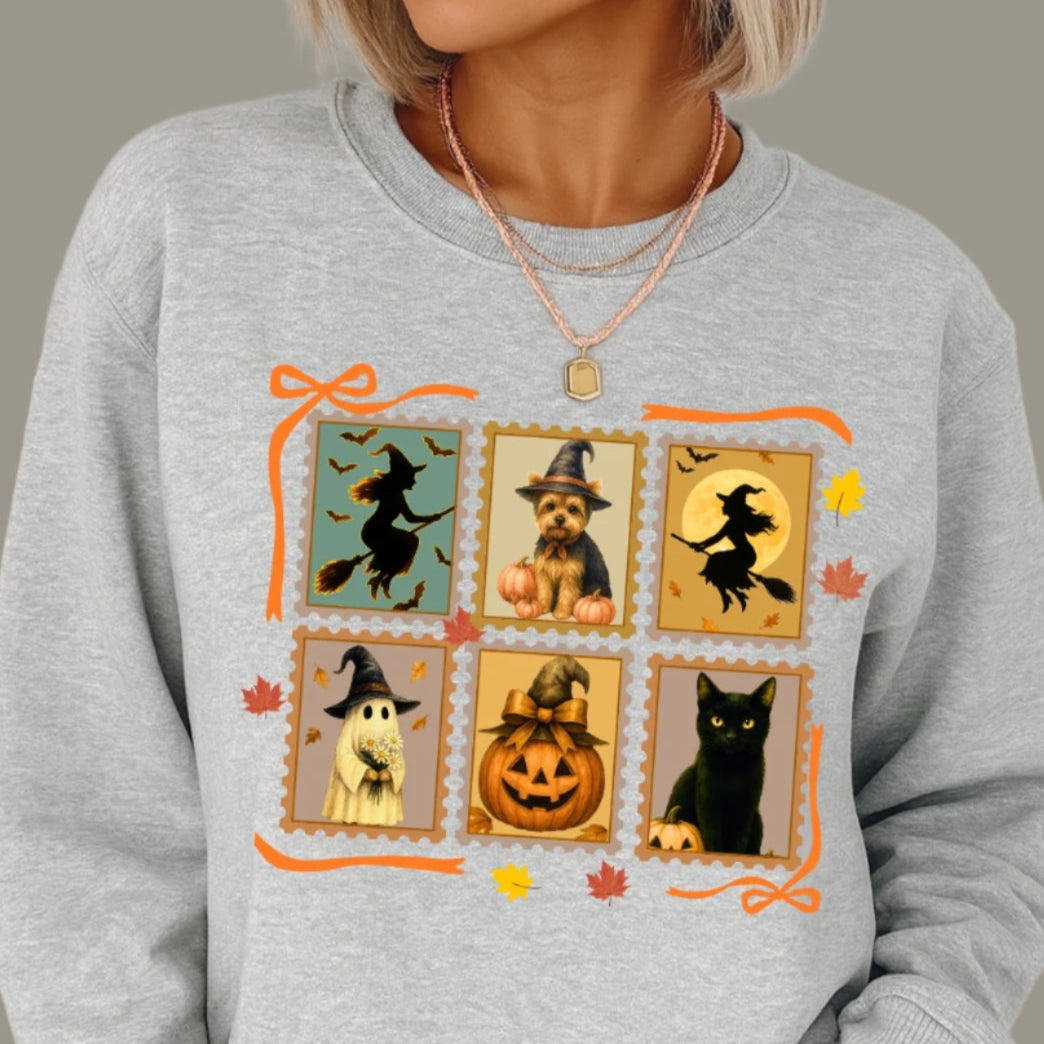 Gray sweatshirt with Halloween-themed design featuring pumpkins, cats, and witches.