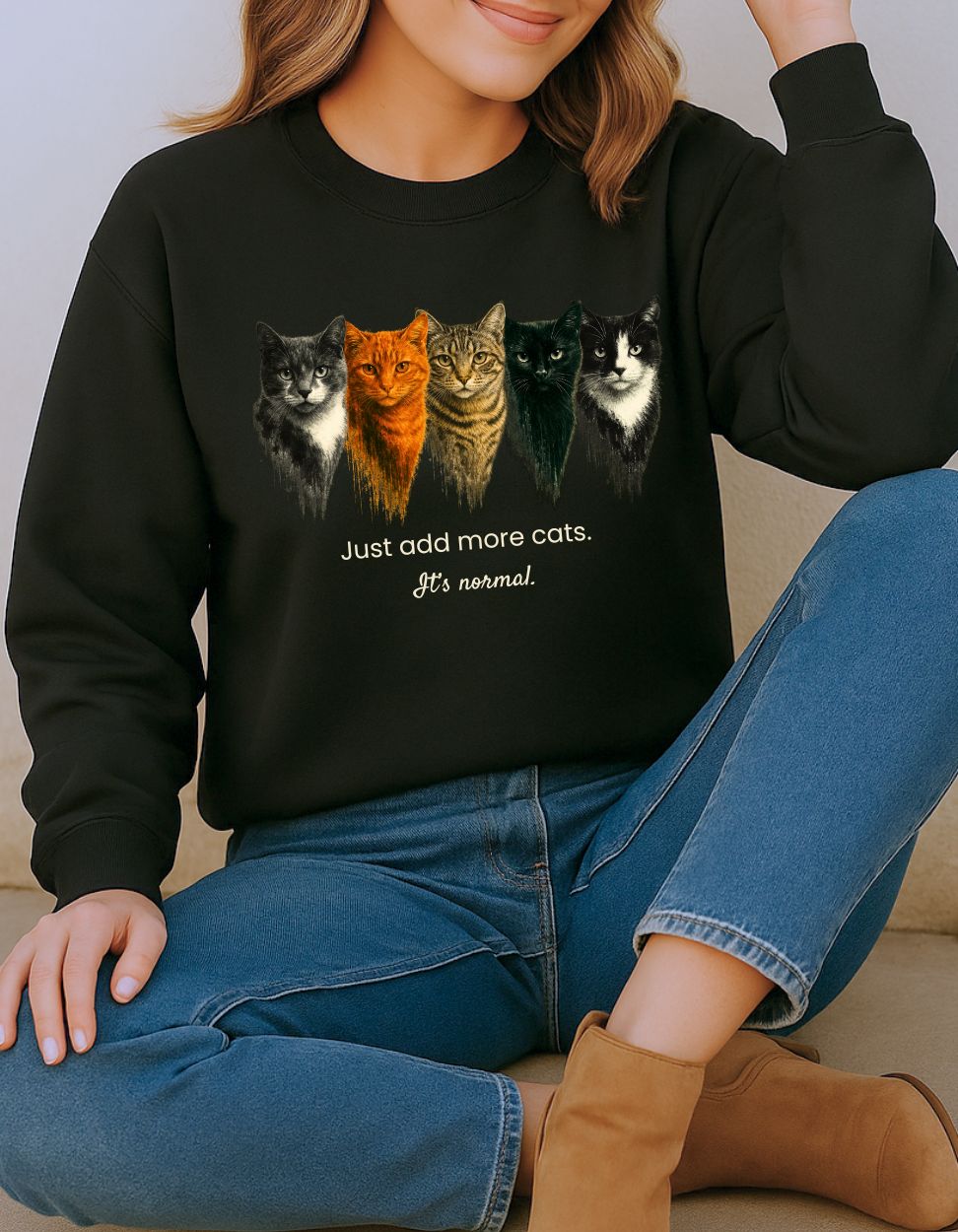 Person wearing a black cat lover sweatshirt with cat illustrations and text.