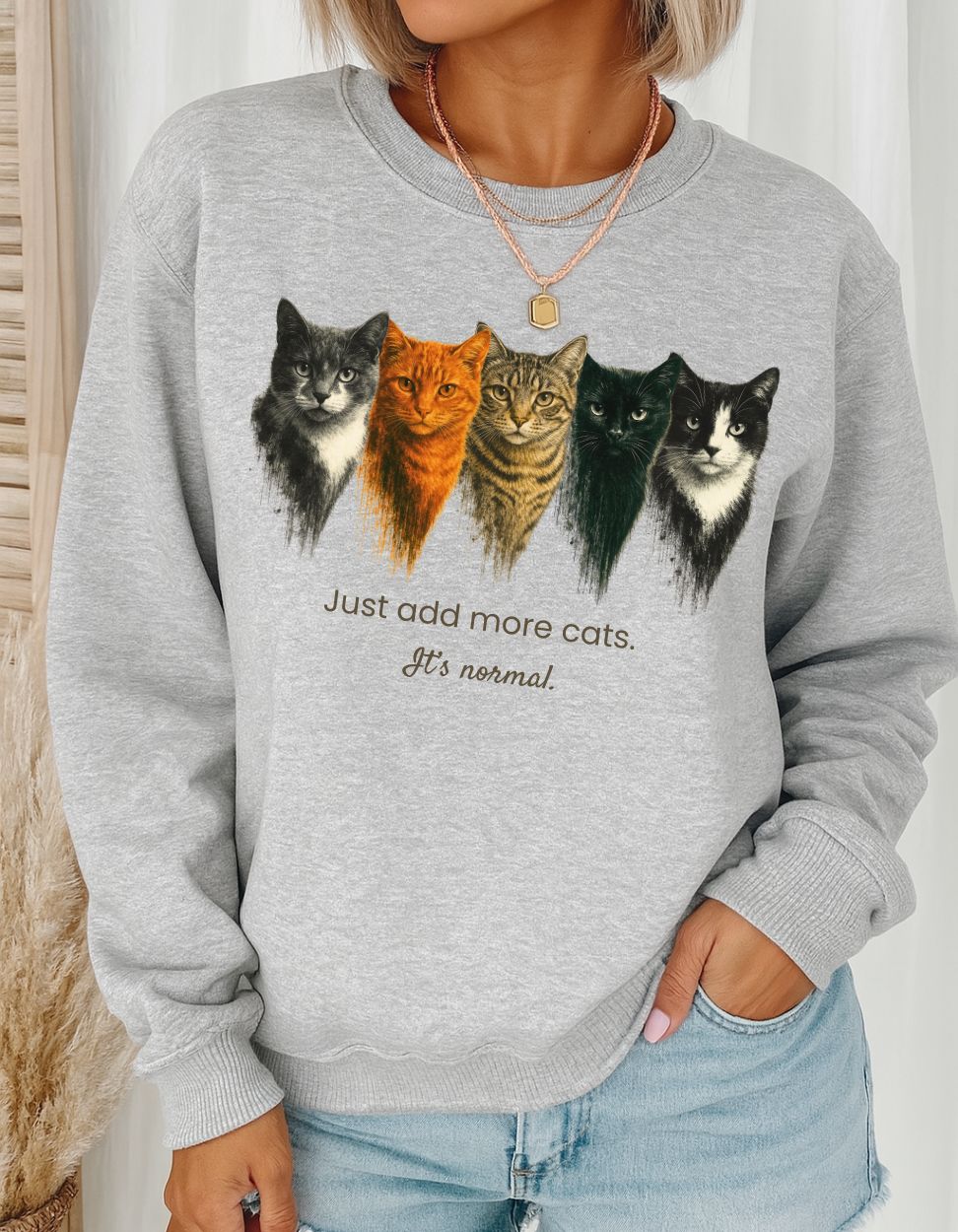 Sport Gray sweatshirt with cat illustrations and text worn by a person.