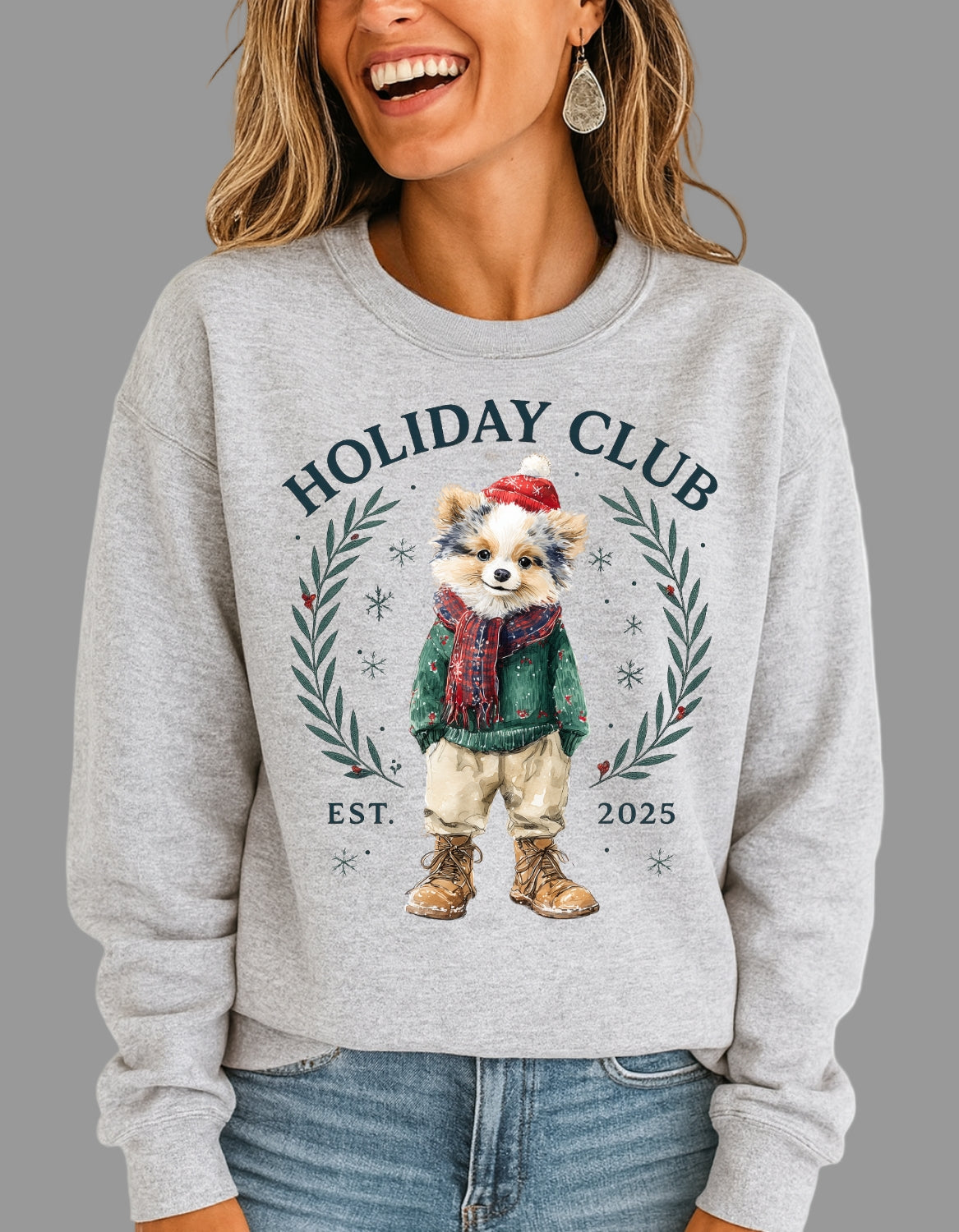 Person wearing a gray sweatshirt with a holiday-themed design featuring a dog and text.
