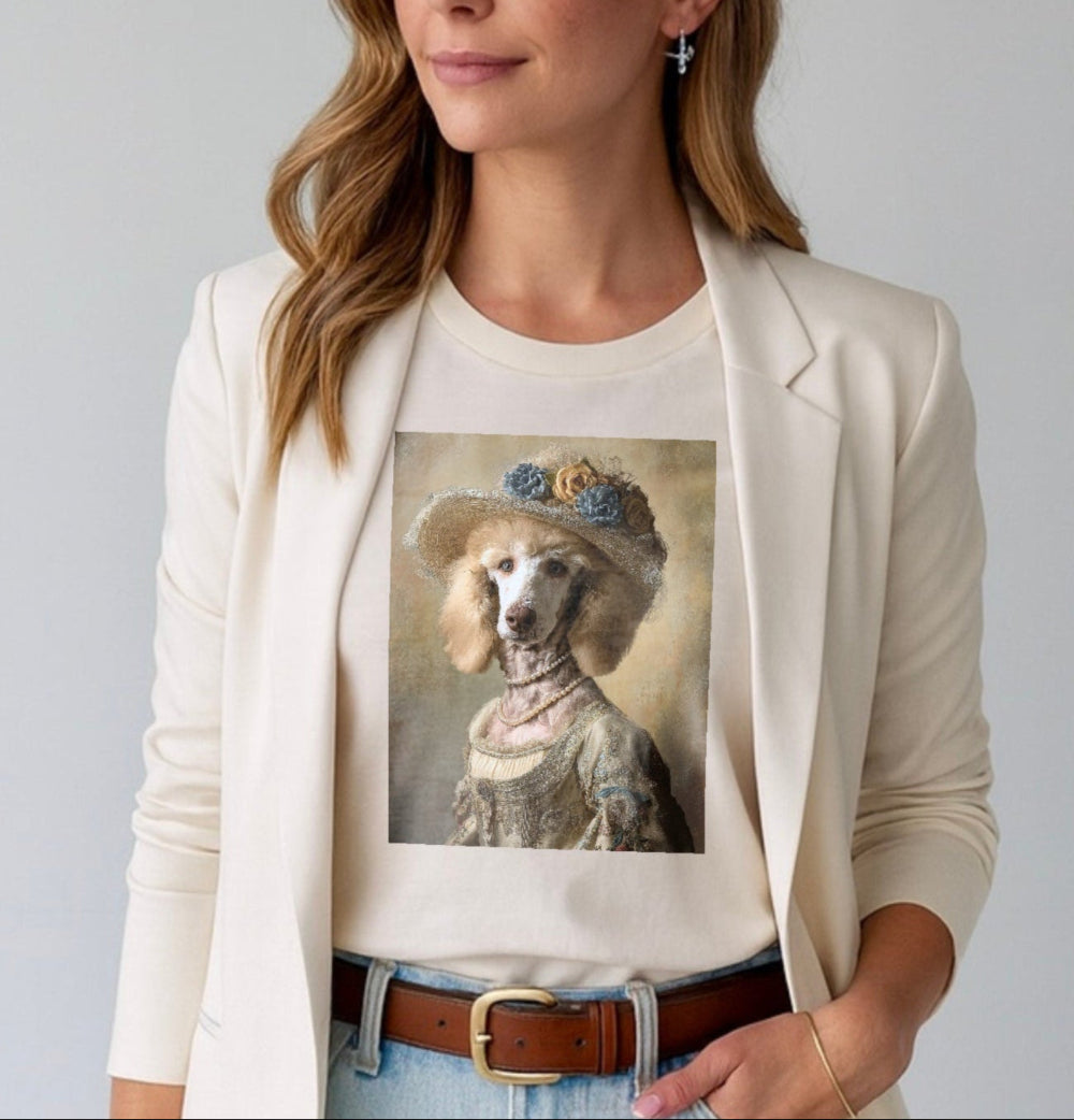 Woman wearing a white t-shirt with a dog's portrait and a beige blazer on a plain background
