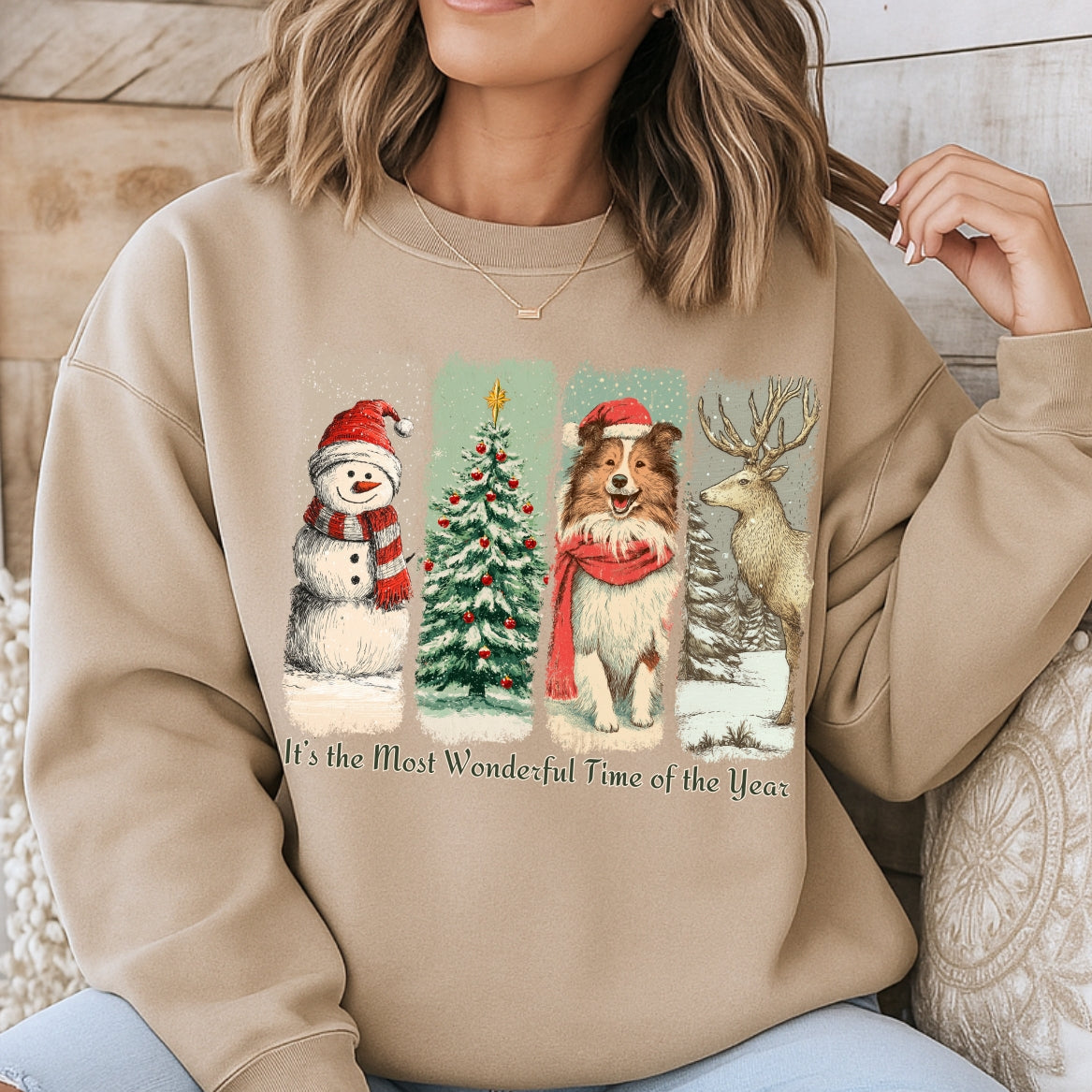 Person wearing a beige sweatshirt with Christmas-themed graphics and text.