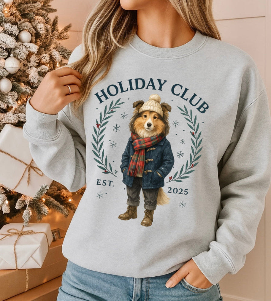 Person wearing a sweater with a bear graphic and 'Holiday Club' text, Christmas tree and gifts in the background