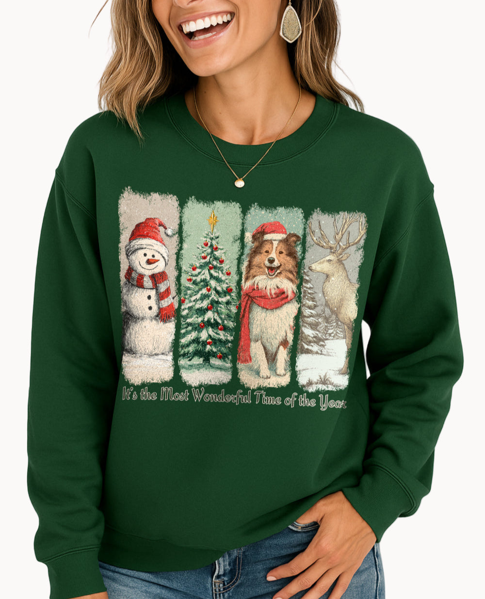 Woman wearing a green sweatshirt with Christmas-themed design featuring a snowman, tree, dog, and deer.