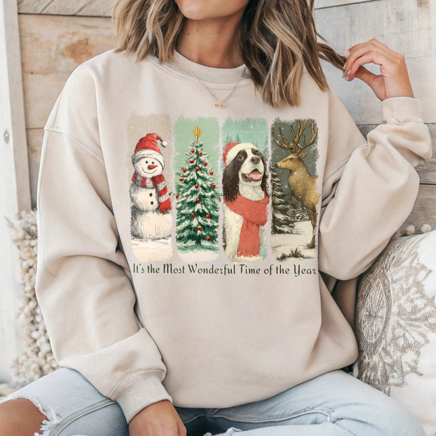 Person wearing a beige sweatshirt with Christmas-themed graphics and text.