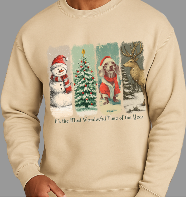 Beige sweatshirt with Christmas-themed design featuring a snowman, tree, dog, and deer, worn by a person.