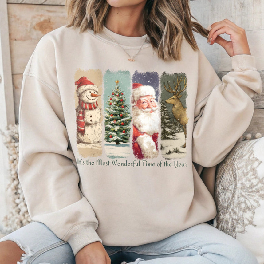 Person wearing a beige sweatshirt with Christmas-themed graphics and text.
