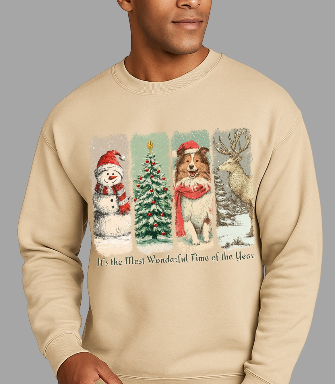 Beige sweatshirt with Christmas-themed design featuring a snowman, tree, dog, and deer on a gray background.