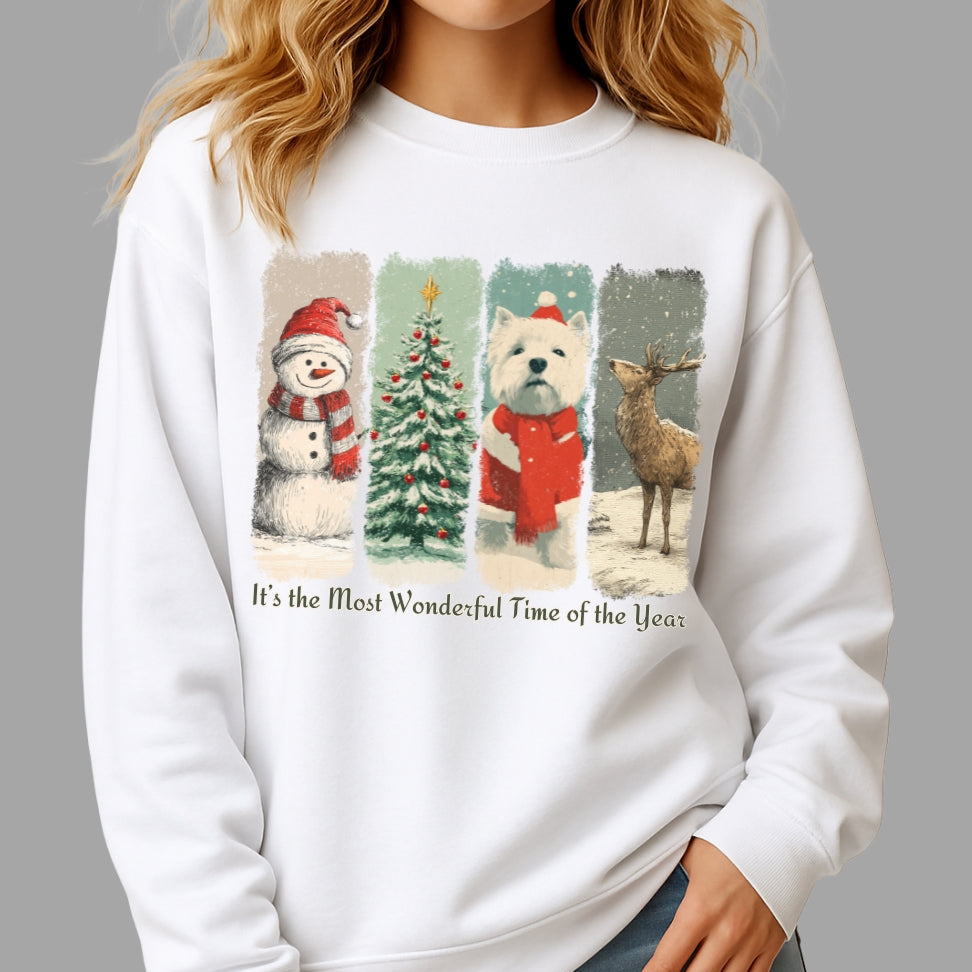 White sweatshirt with Christmas-themed design featuring a snowman, tree, dog, and deer, worn by a person.