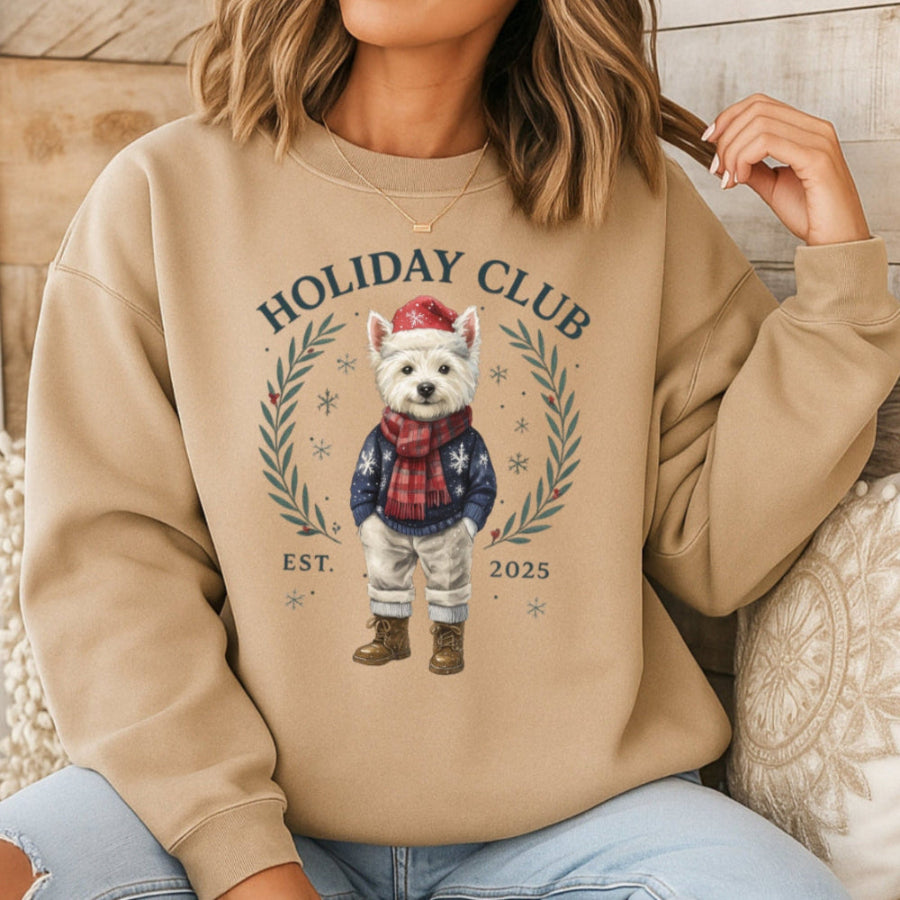 Person wearing a beige sweatshirt with a holiday-themed design featuring a dog and text.