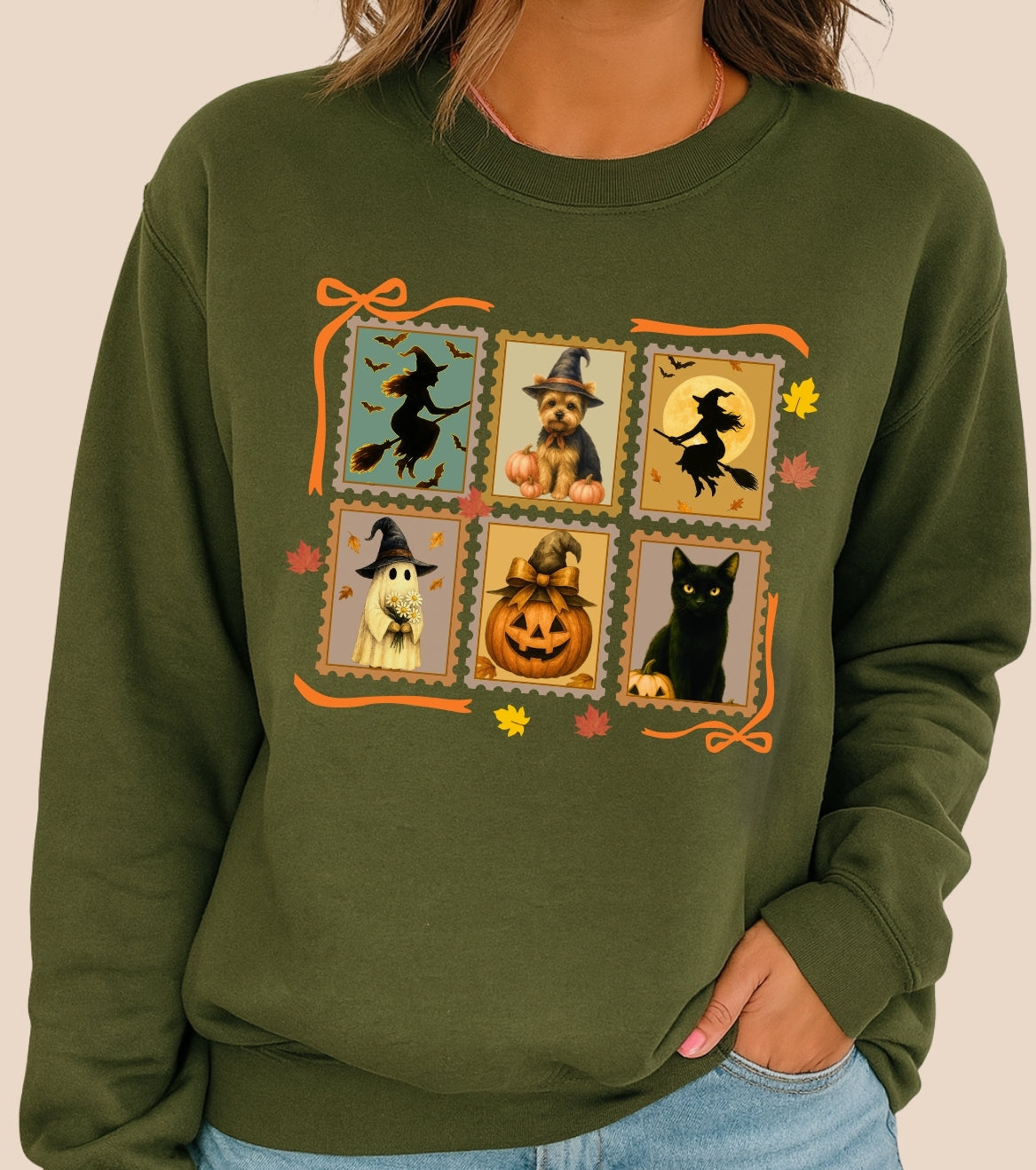 Green sweatshirt with Halloween-themed design featuring pumpkins, cats, and witches.