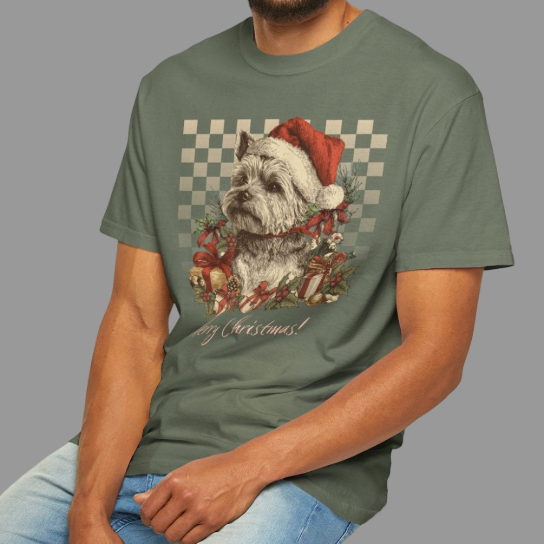 Man wearing a green t-shirt with a graphic design, sitting on a stool against a white background