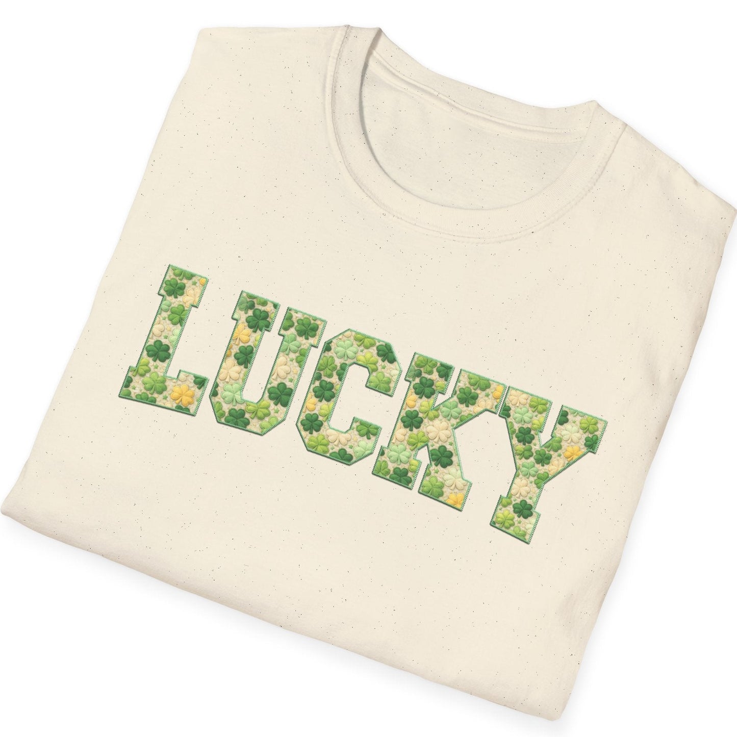 Folded cream-colored sweatshirt with 'LUCKY' printed in green floral letters on a white background
