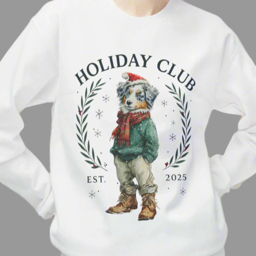 Person wearing a white sweatshirt with 'Holiday Club' design on a white background