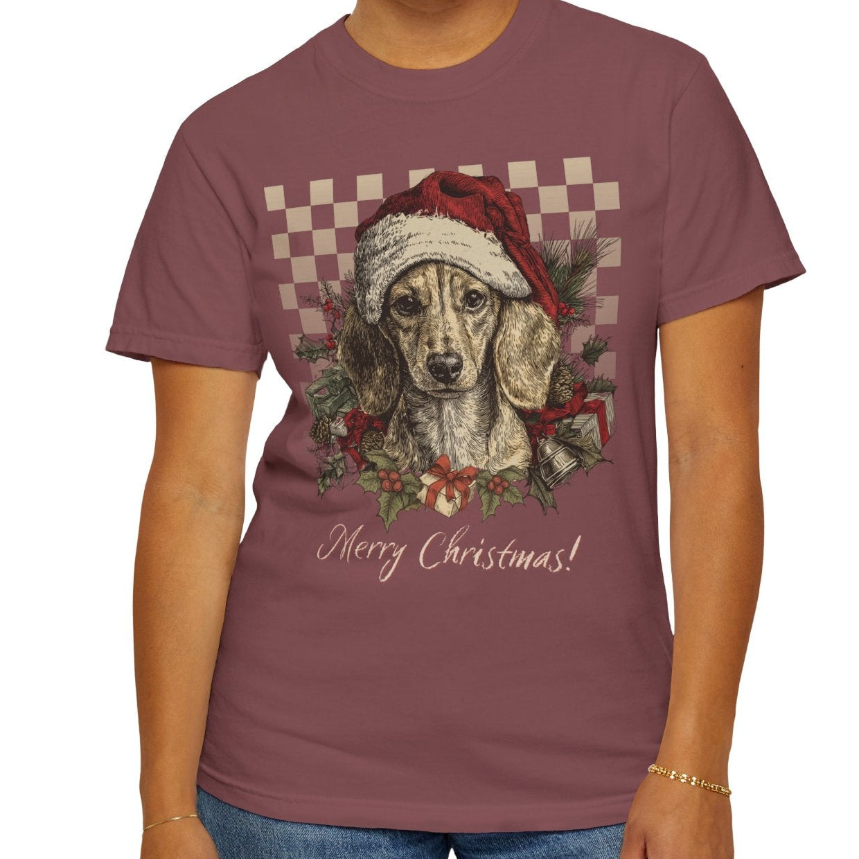 Woman wearing a purple t-shirt with a Christmas-themed graphic of a dog wearing a Santa hat.