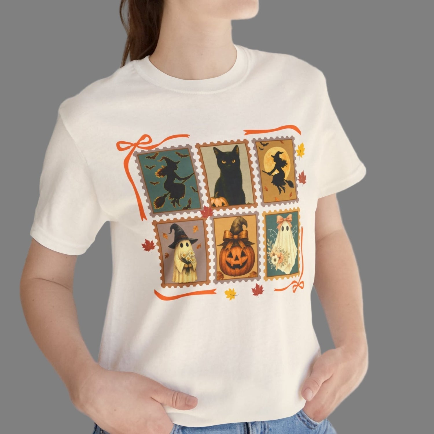 Person wearing a white t-shirt with Halloween-themed design, standing against a plain background.