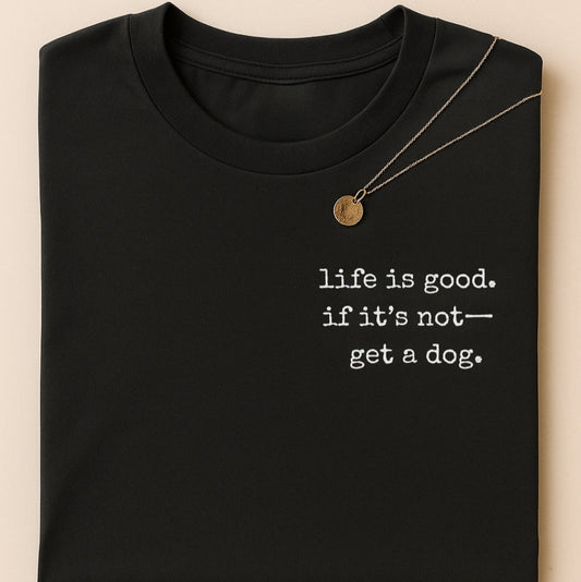 Black t-shirt with 'life is good. if it's not-get a dog.' text on a beige background
