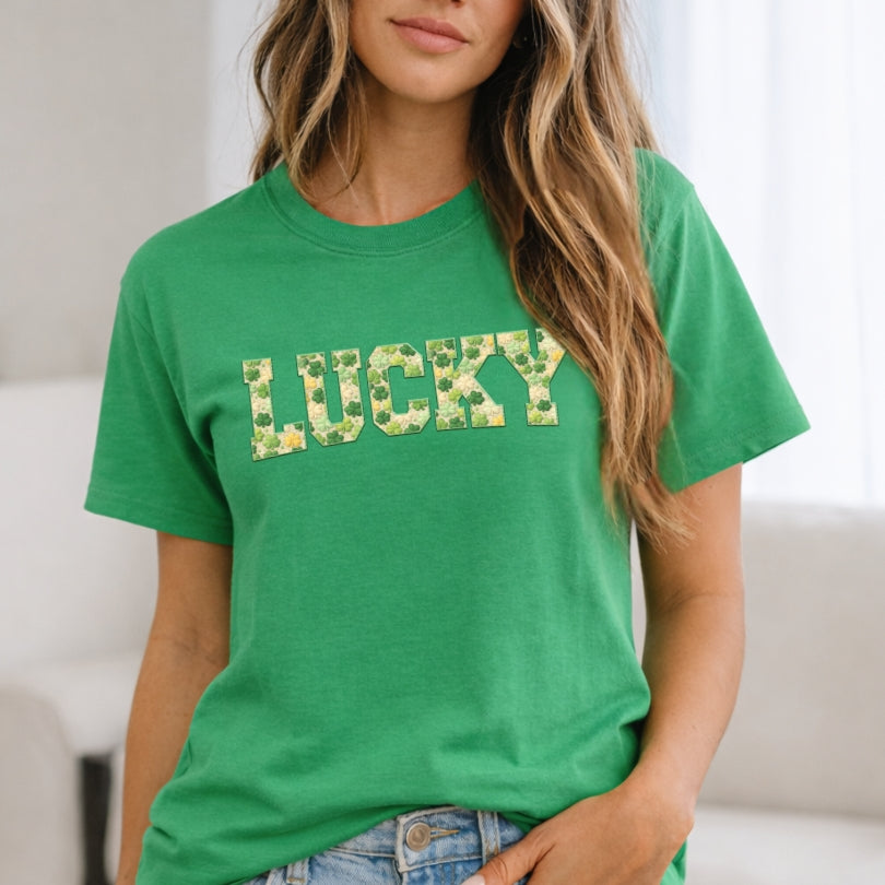 Person wearing a green t-shirt with 'LUCKY' printed on it.