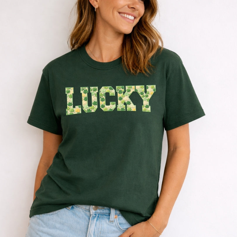 Person wearing a green t-shirt with 'LUCKY' printed on it against a white background