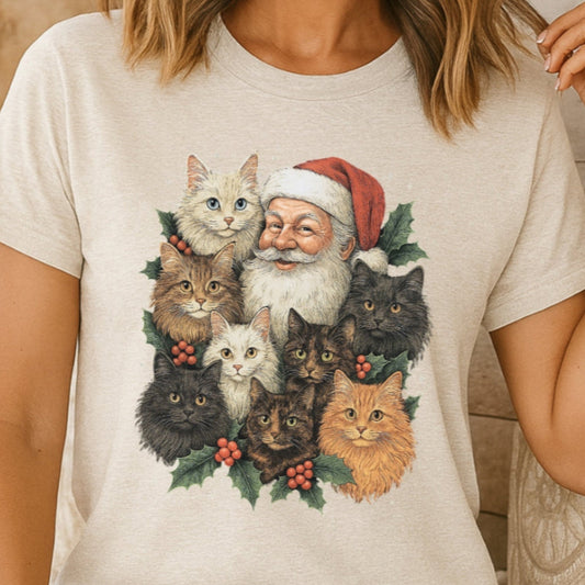 Person wearing a t-shirt with a Christmas-themed design of Santa Claus and cats.
